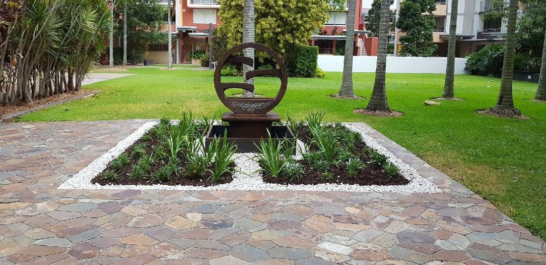 Paved garden with a raised feature bed and sculpture, Kelvin Grove