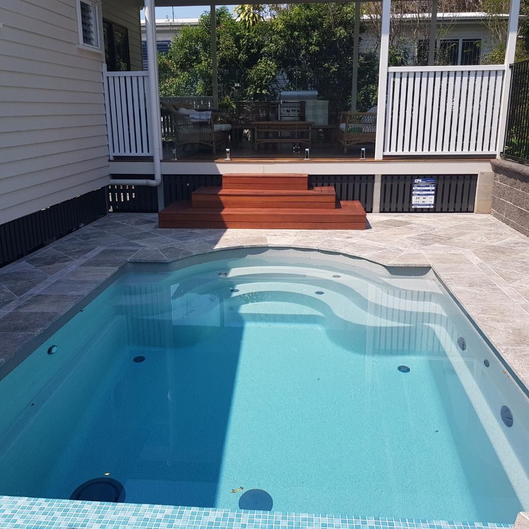 Plunge pool with paved surround and timber steps