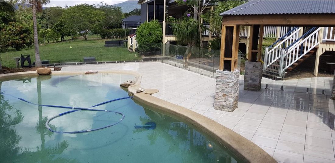 Tiled pool area beside a timber gazebo