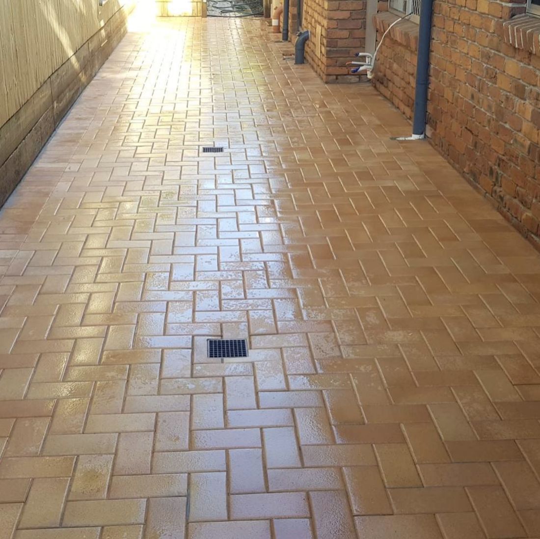 Paved side path with a drain grate